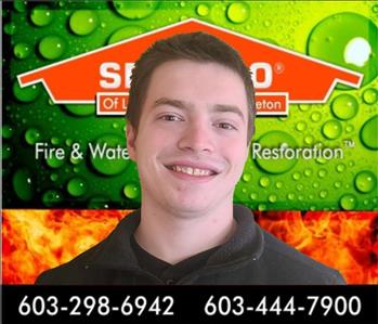 crew photo of man in front of servpro background