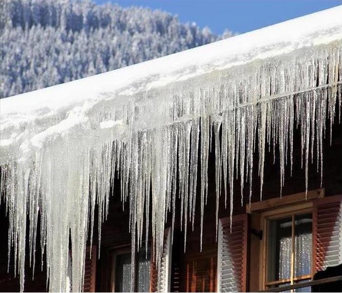 picture of a lot of icicles hanging off of house